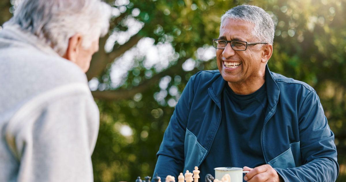 Smiling man, playing chess